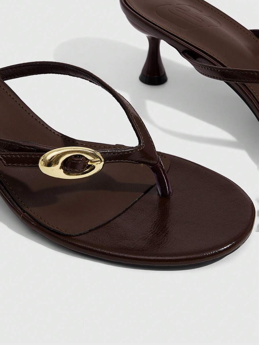 Women's slingback heeled sandals featuring a button toe post accent, sleek mid pyramid heel, and smooth faux leather finish.