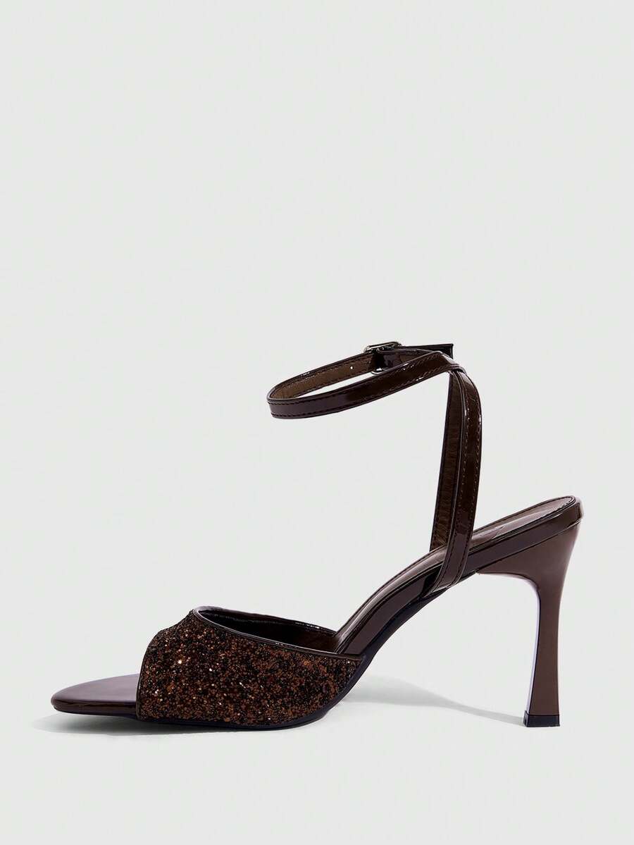 Sequin decorated high heel sandals featuring an open toe design, stiletto heel, and adjustable ankle strap buckle.