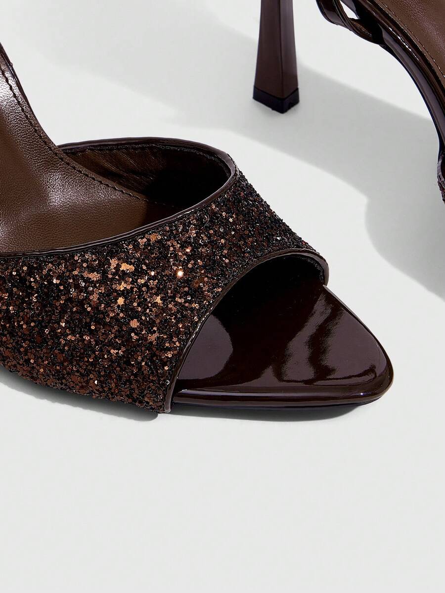 Sequin decorated high heel sandals featuring an open toe design, stiletto heel, and adjustable ankle strap buckle.