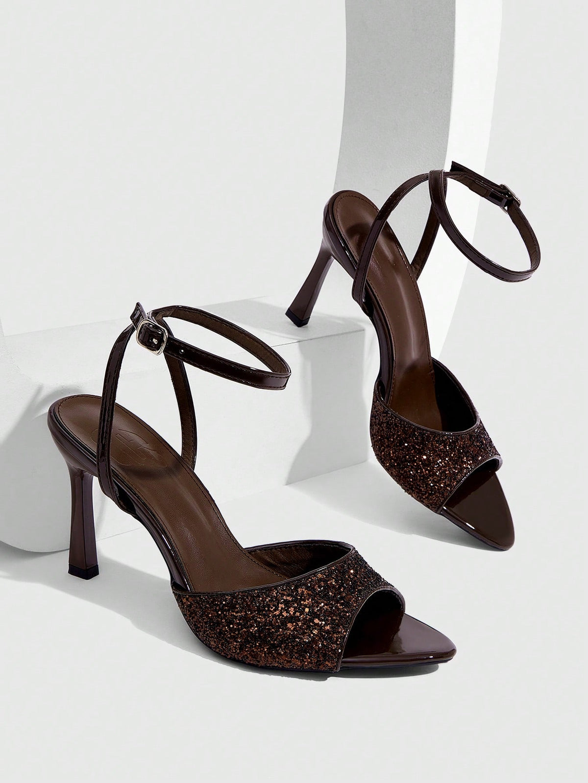 Sequin decorated high heel sandals featuring an open toe design, stiletto heel, and adjustable ankle strap buckle.