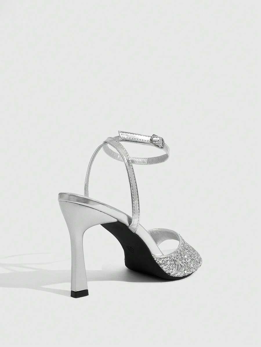 Sequin decorated high heel sandals featuring an open toe design, stiletto heel, and adjustable ankle strap buckle.