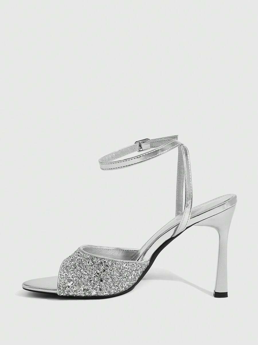 Sequin decorated high heel sandals featuring an open toe design, stiletto heel, and adjustable ankle strap buckle.