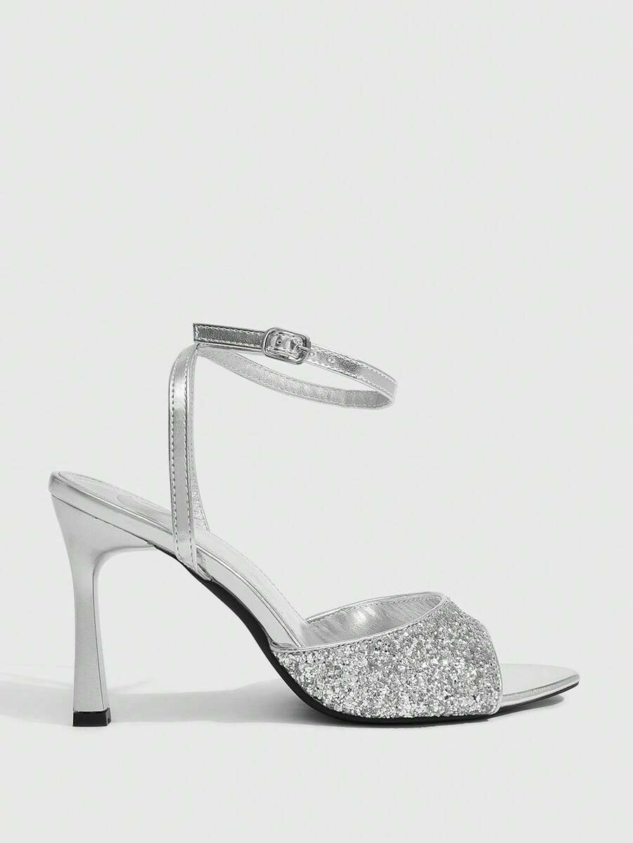 Sequin decorated high heel sandals featuring an open toe design, stiletto heel, and adjustable ankle strap buckle.