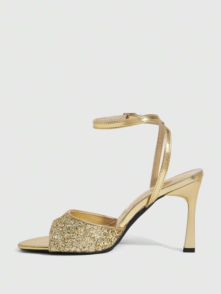 Sequin decorated high heel sandals featuring an open toe design, stiletto heel, and adjustable ankle strap buckle.