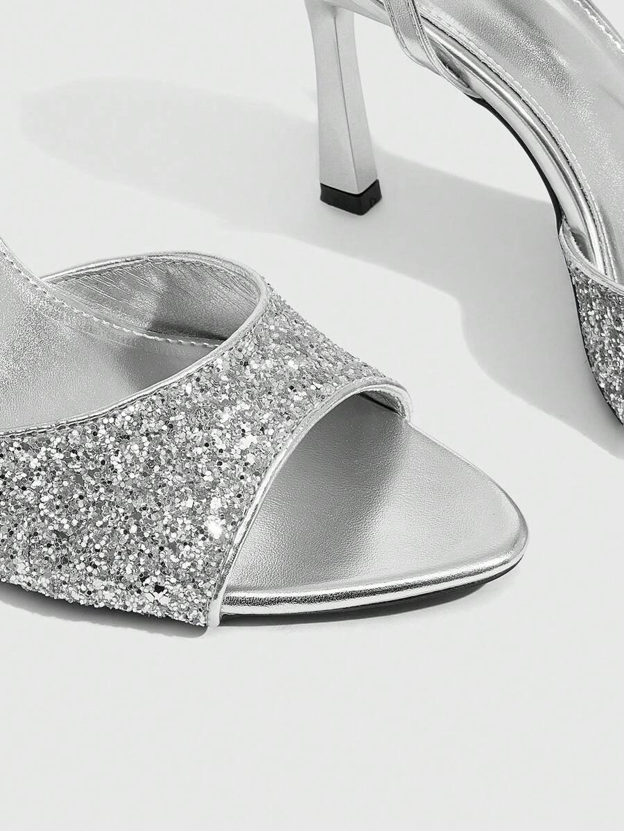 Sequin decorated high heel sandals featuring an open toe design, stiletto heel, and adjustable ankle strap buckle.