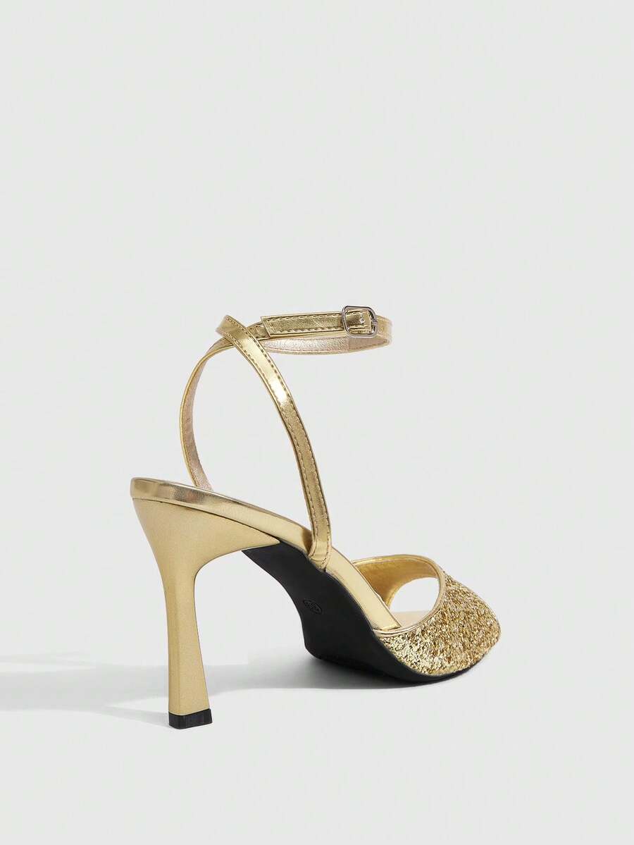 Sequin decorated high heel sandals featuring an open toe design, stiletto heel, and adjustable ankle strap buckle.