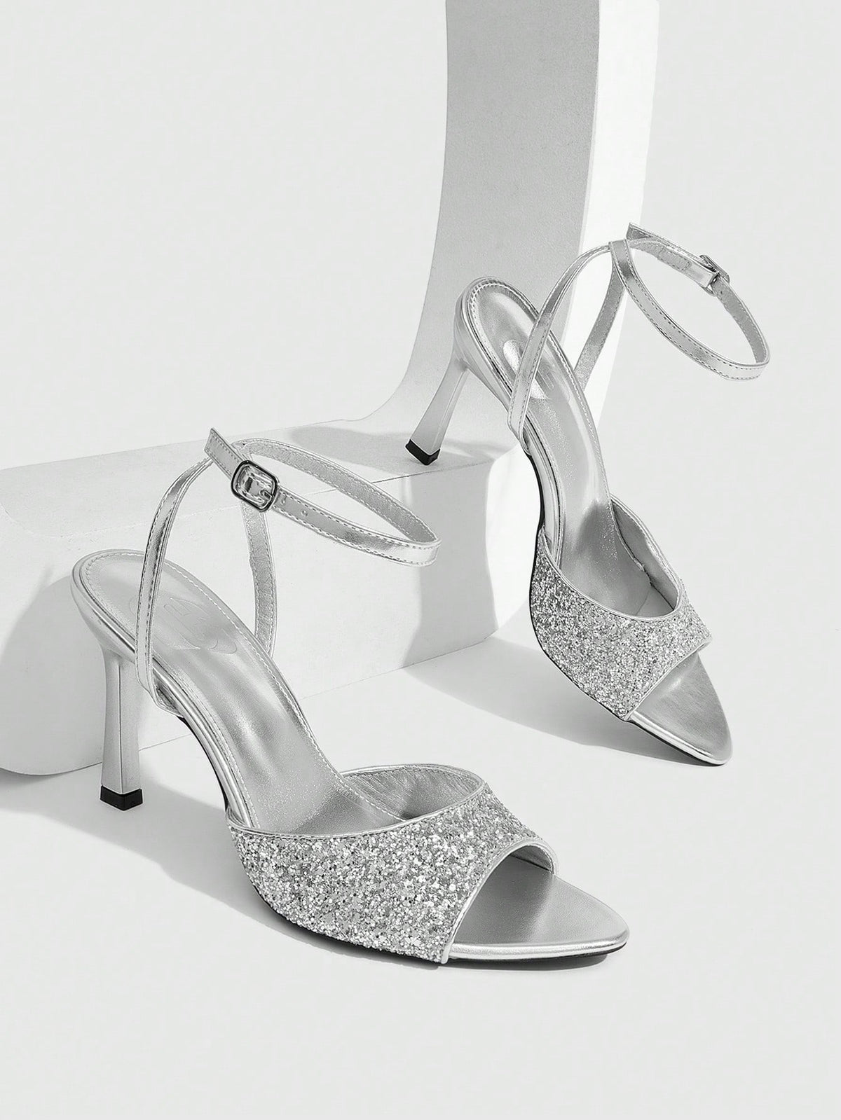 Sequin decorated high heel sandals featuring an open toe design, stiletto heel, and adjustable ankle strap buckle.