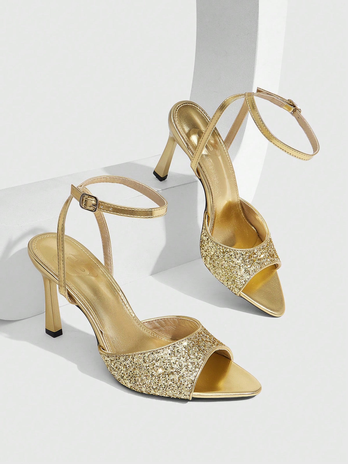 Sequin decorated high heel sandals featuring an open toe design, stiletto heel, and adjustable ankle strap buckle.