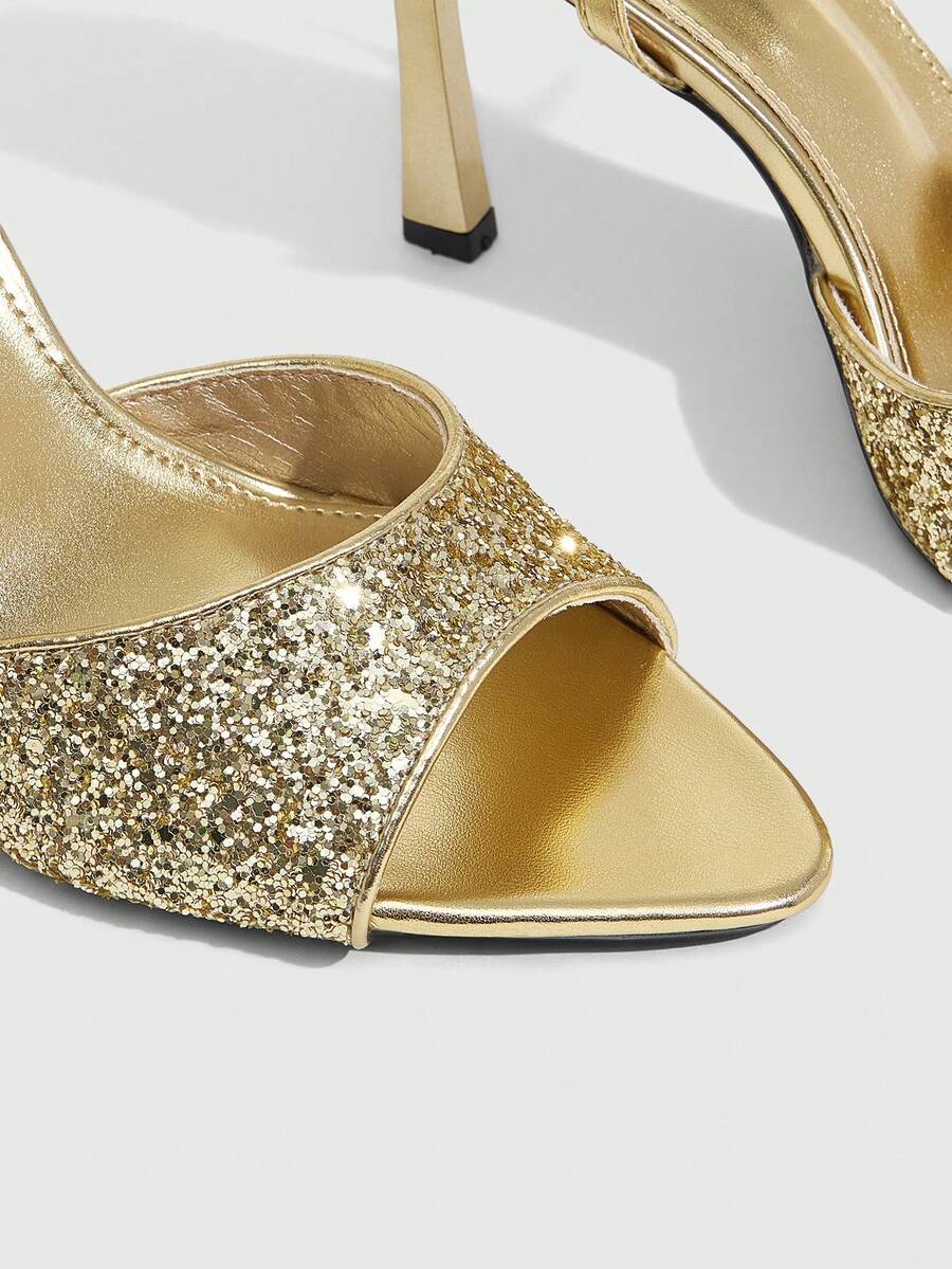 Sequin decorated high heel sandals featuring an open toe design, stiletto heel, and adjustable ankle strap buckle.