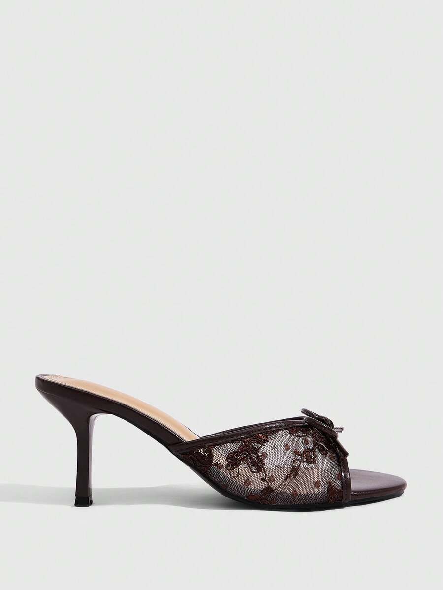 Open toe high heel slide sandals featuring lace details and a bow accent on the upper strap.