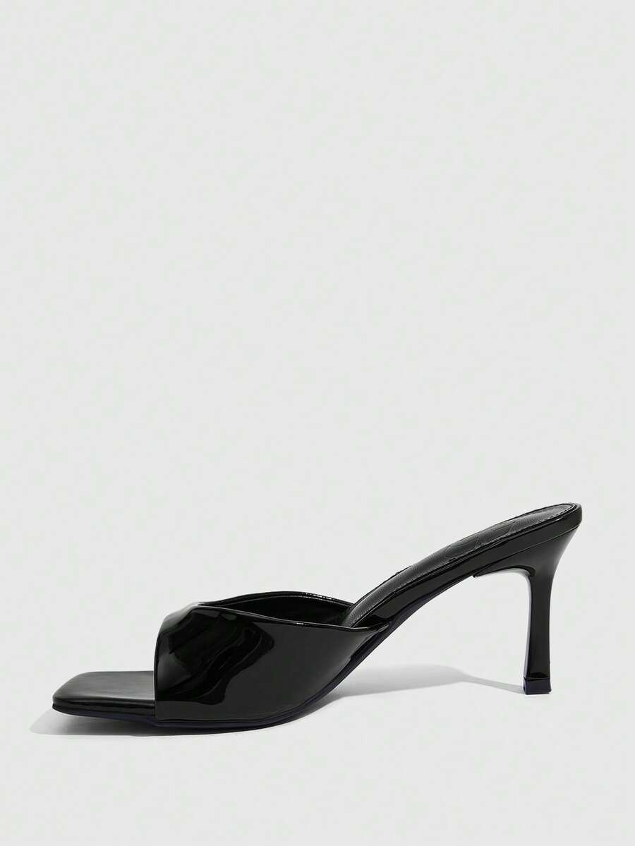 Women's black square toe high heel sandals featuring an open toe design, thin stiletto heel, and slingback strap.