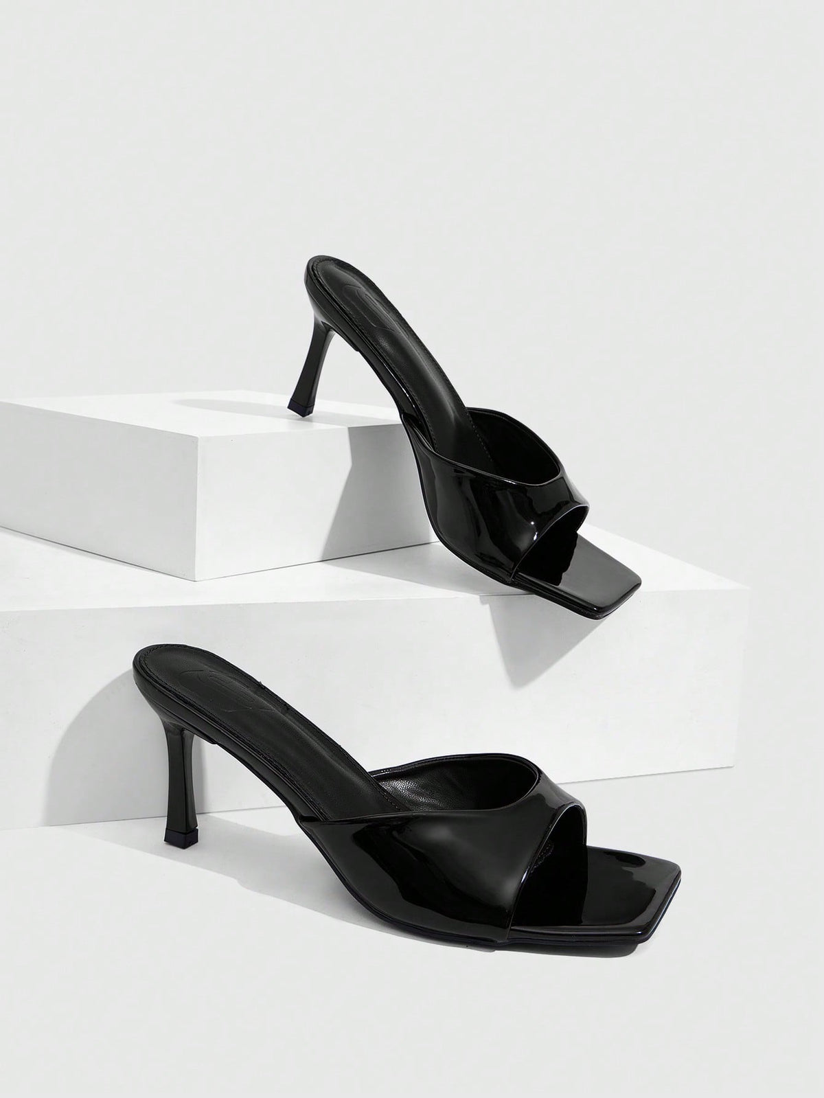 Women's black square toe high heel sandals featuring an open toe design, thin stiletto heel, and slingback strap.