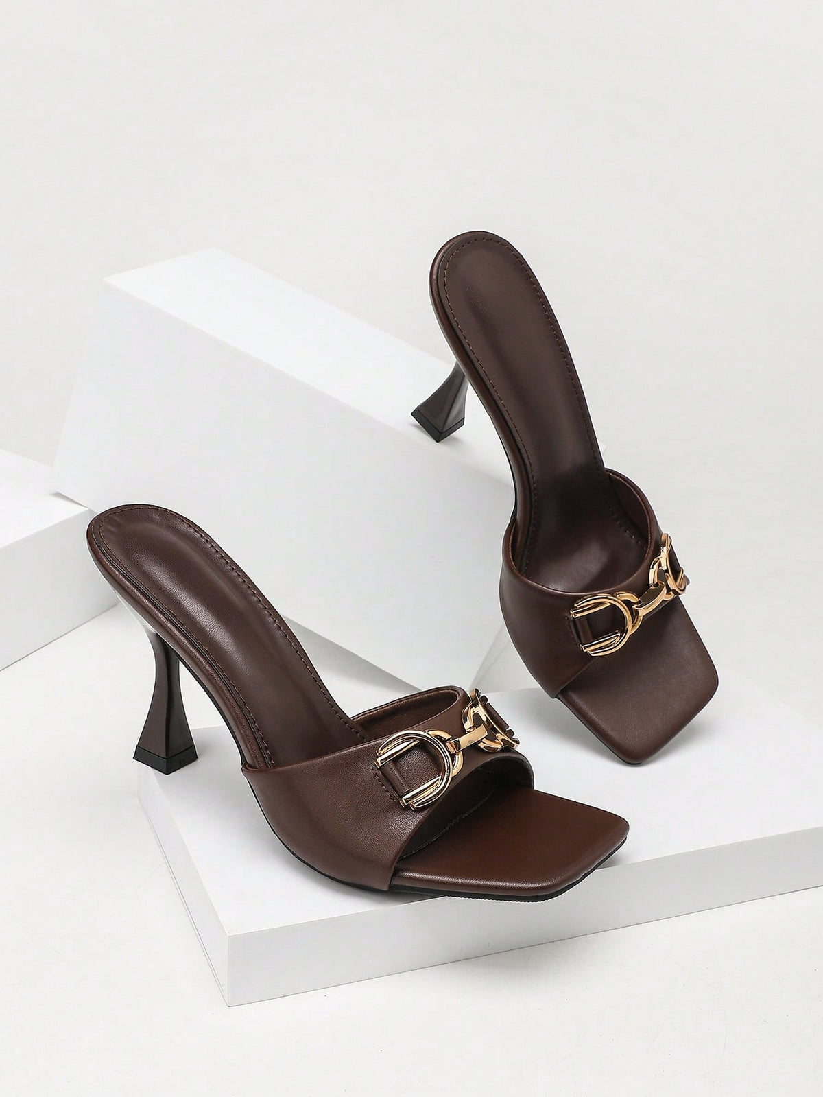 Women's open square toe slender high heel sandals with slingback strap and metal buckle detailing.