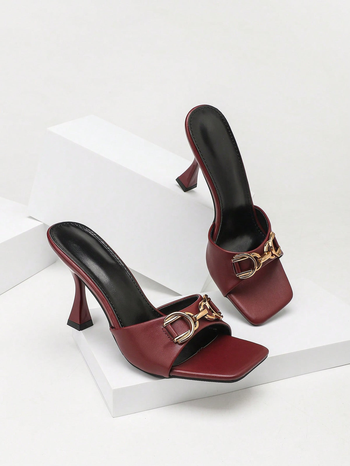 Women's open square toe slender high heel sandals with slingback strap and metal buckle detailing.