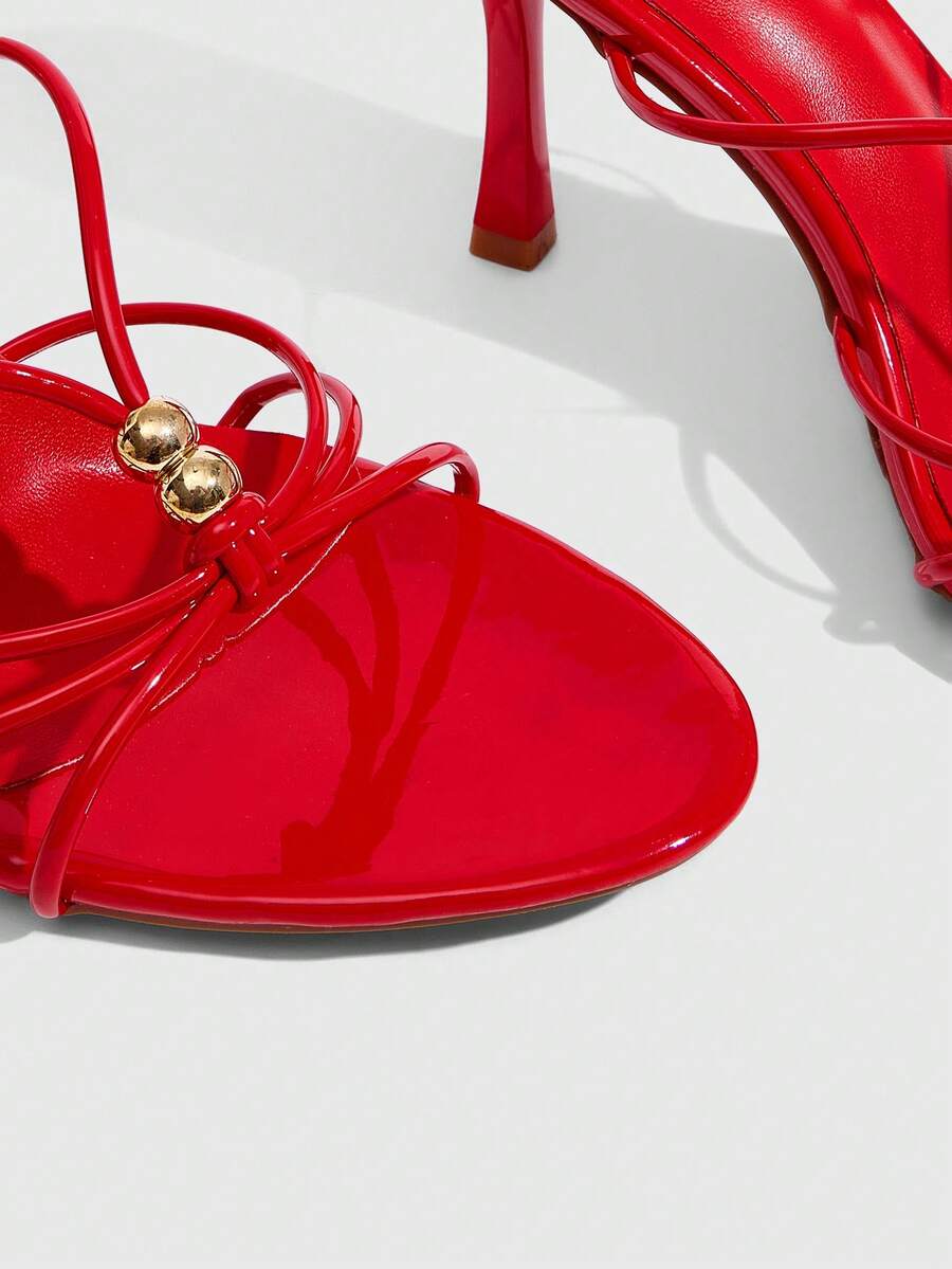 Burgundy stiletto high heel sandals featuring open toe thin straps and knot details