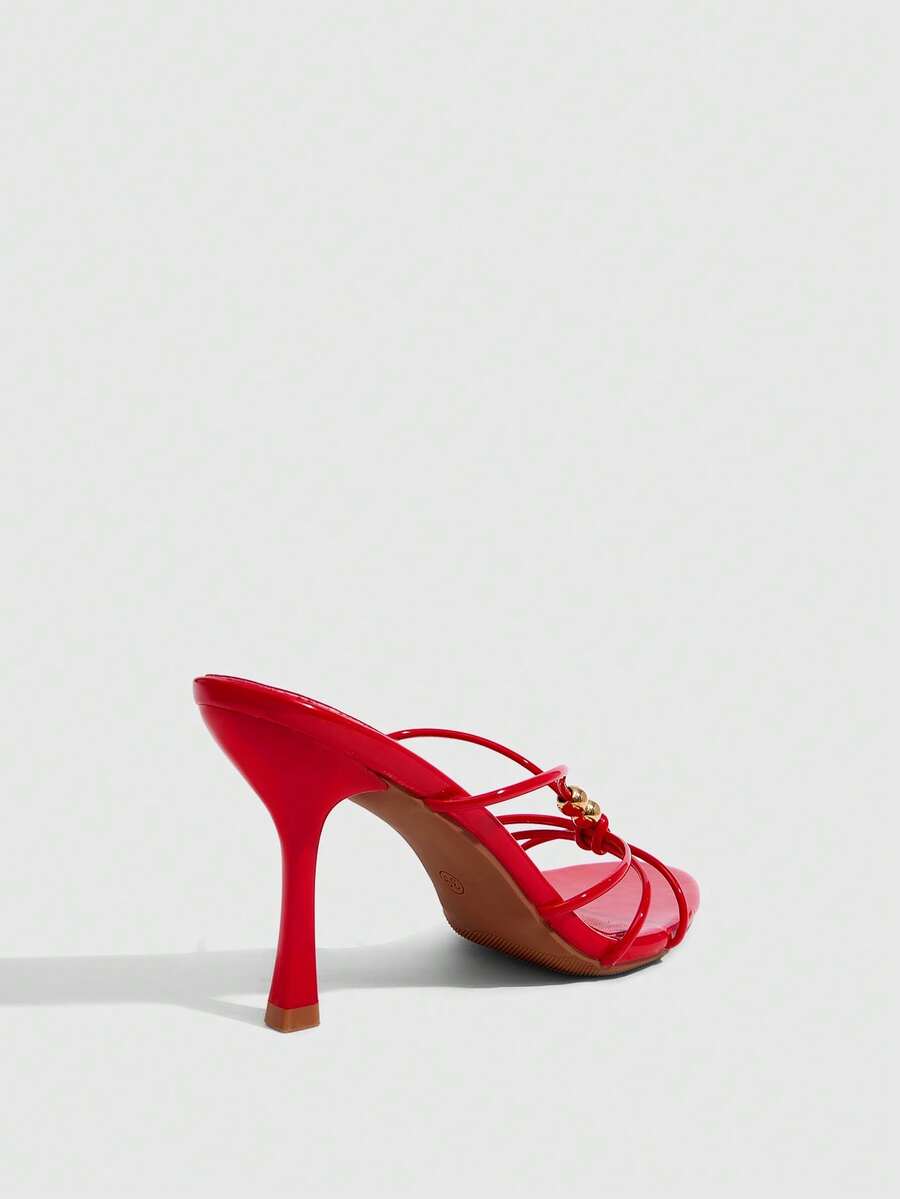 Burgundy stiletto high heel sandals featuring open toe thin straps and knot details