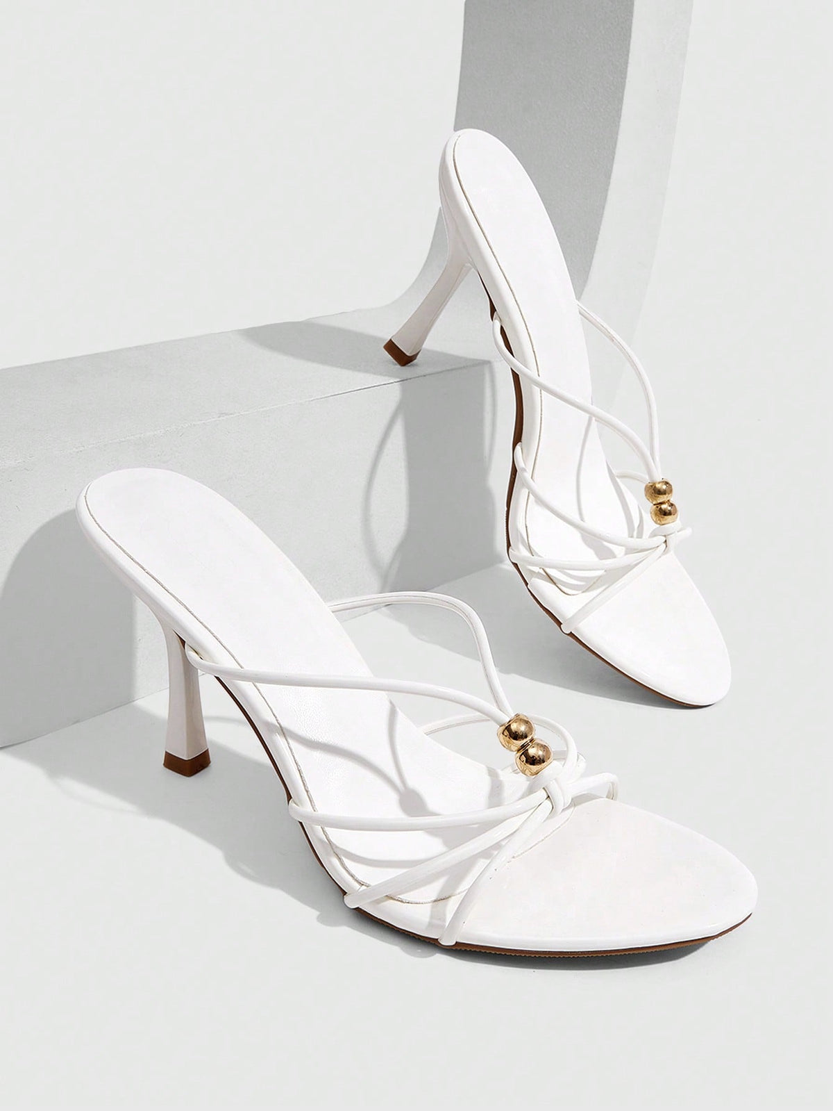 Burgundy stiletto high heel sandals featuring open toe thin straps and knot details