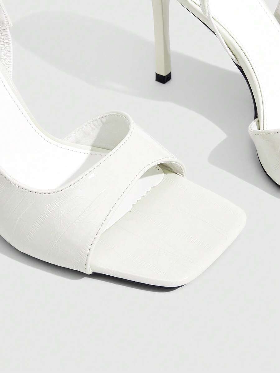 Women's burgundy open toe high heel sandals featuring an embossed finish and slingback strap
