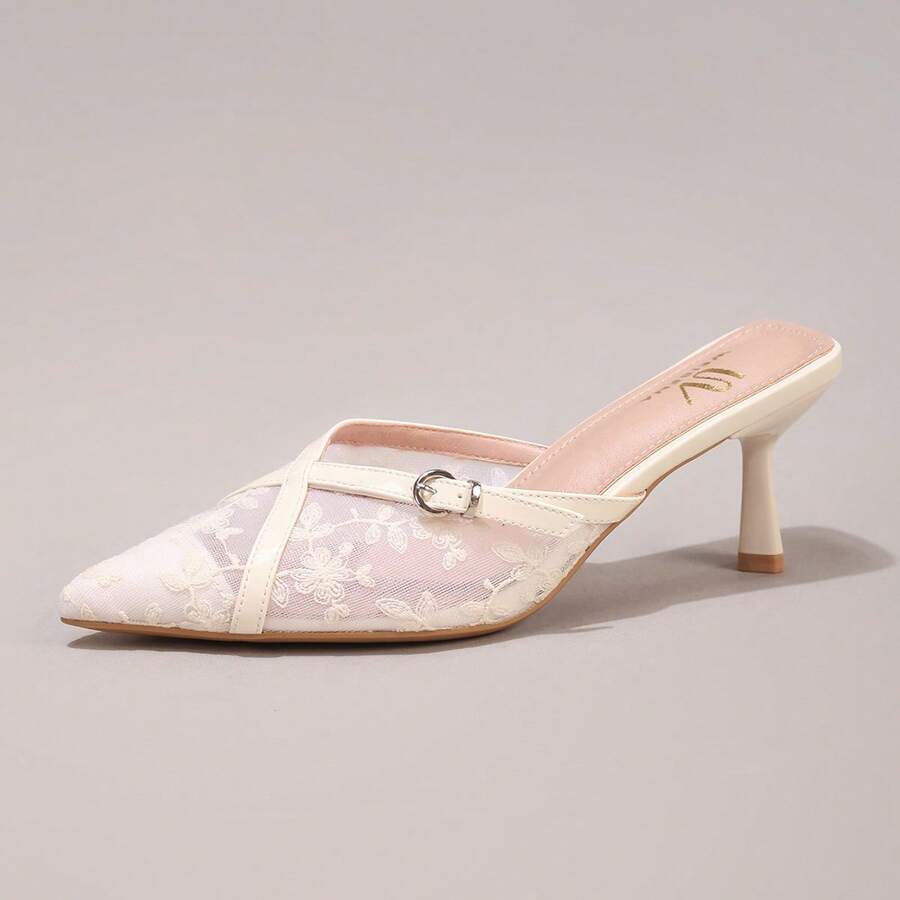 Pair of women's white pointed-toe kitten heel pumps with slingback straps and sleek patent finish