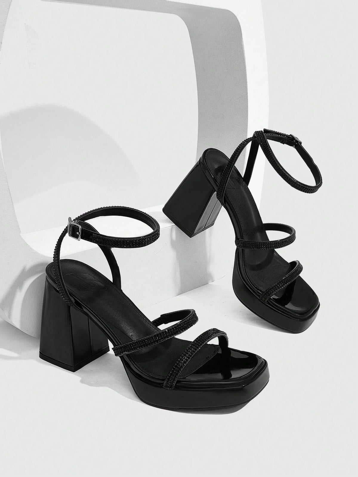 Women's high-heeled sandals with textured pattern, open toe design, chunky heel, and adjustable ankle buckle strap.