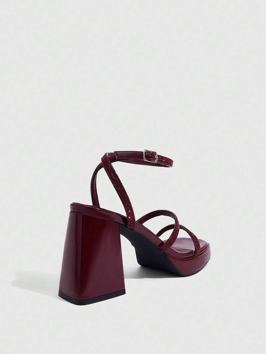 Women's high-heeled sandals with textured pattern, open toe design, chunky heel, and adjustable ankle buckle strap.
