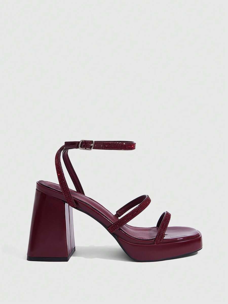 Women's high-heeled sandals with textured pattern, open toe design, chunky heel, and adjustable ankle buckle strap.