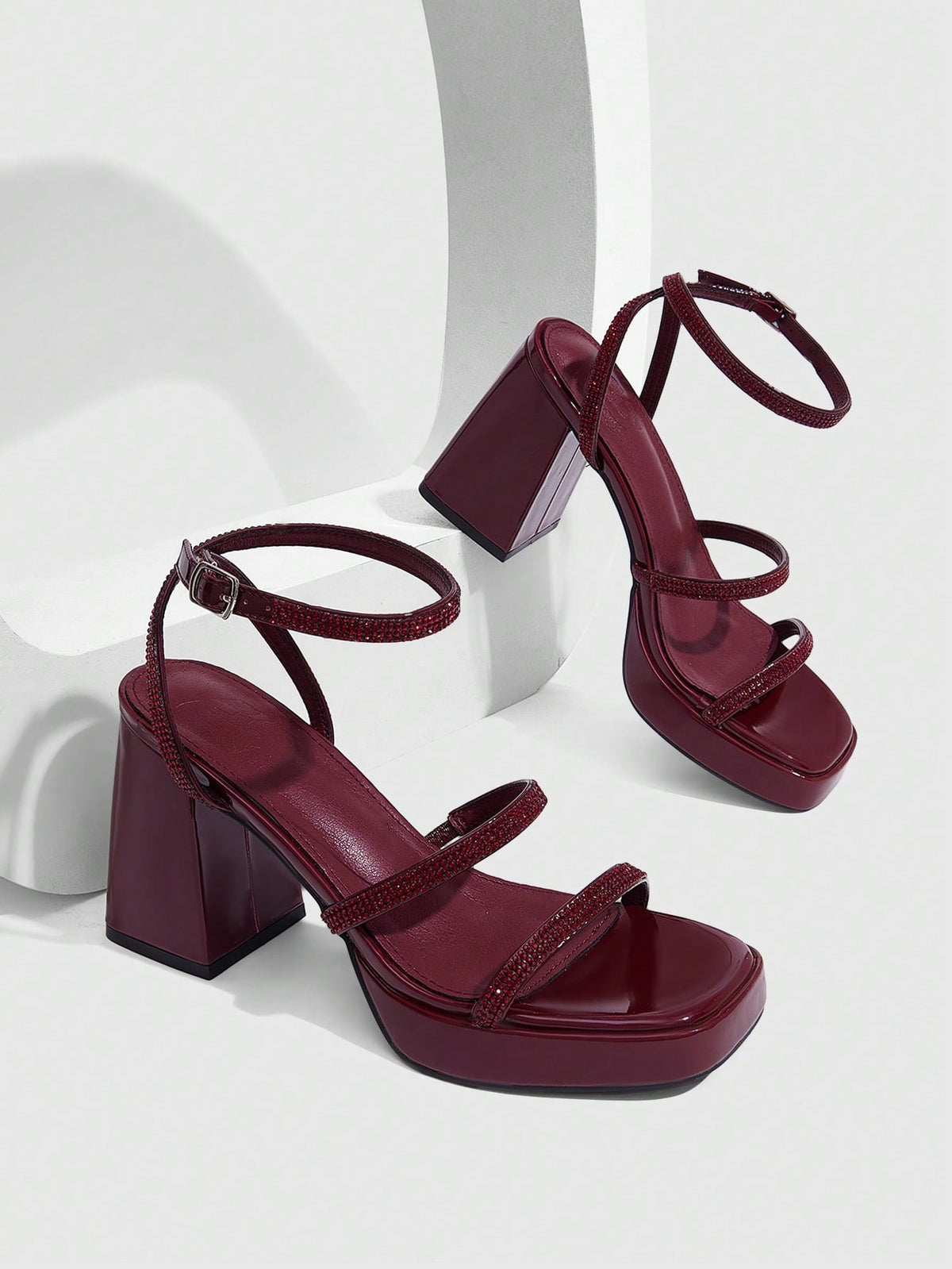 Women's high-heeled sandals with textured pattern, open toe design, chunky heel, and adjustable ankle buckle strap.