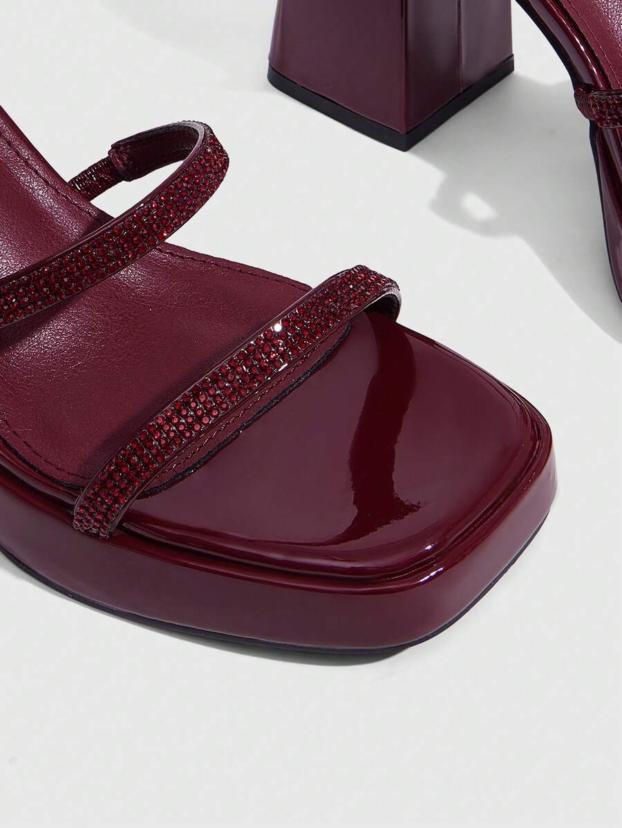 Women's high-heeled sandals with textured pattern, open toe design, chunky heel, and adjustable ankle buckle strap.