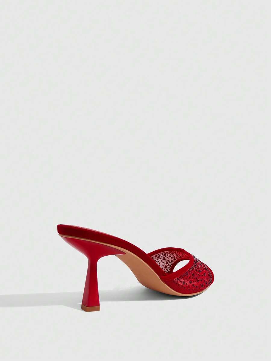 Red mesh pointed open-toe stiletto high-heeled sandals and mules embellished with sparkling rhinestones for wedding and banquet occasions.