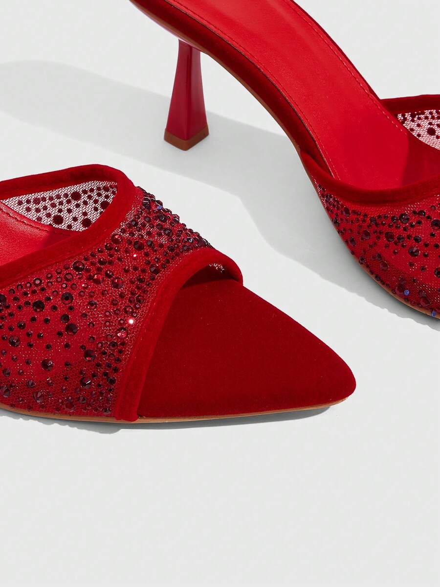 Red mesh pointed open-toe stiletto high-heeled sandals and mules embellished with sparkling rhinestones for wedding and banquet occasions.