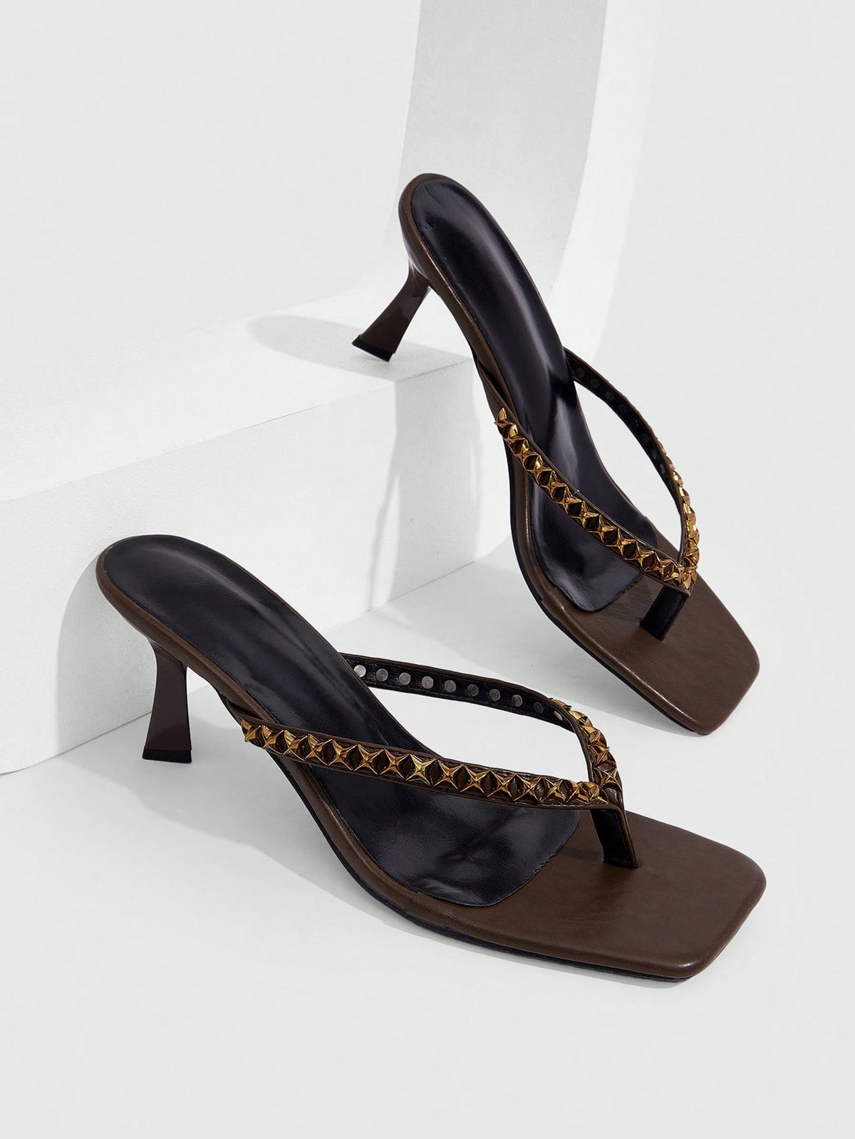 Elegant ladies strappy high-heeled slippers featuring a sleek toe post, buckle accent, and stiletto mid heel in smooth PU leather.