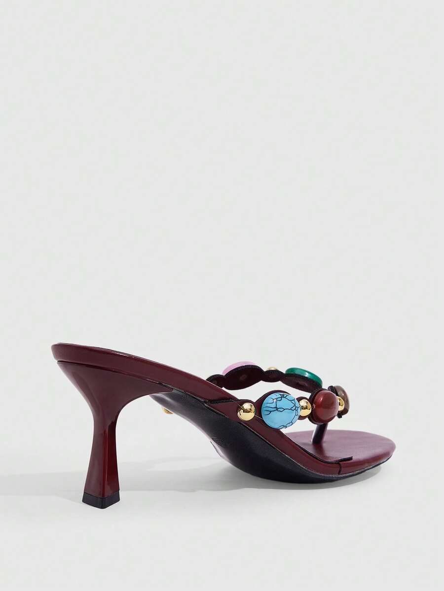 Elegant ladies strappy high-heeled slippers featuring a sleek toe post, buckle accent, and stiletto mid heel in smooth PU leather.