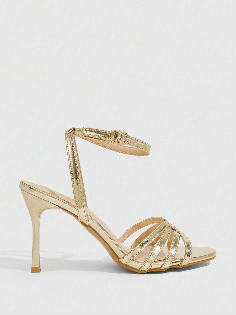 Women's champagne stiletto high heel sandals featuring knotted cross-over straps, open round toe, and adjustable ankle buckle strap.