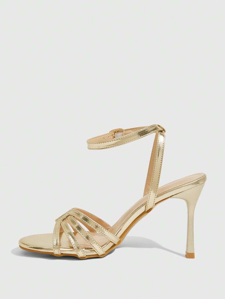 Women's champagne stiletto high heel sandals featuring knotted cross-over straps, open round toe, and adjustable ankle buckle strap.