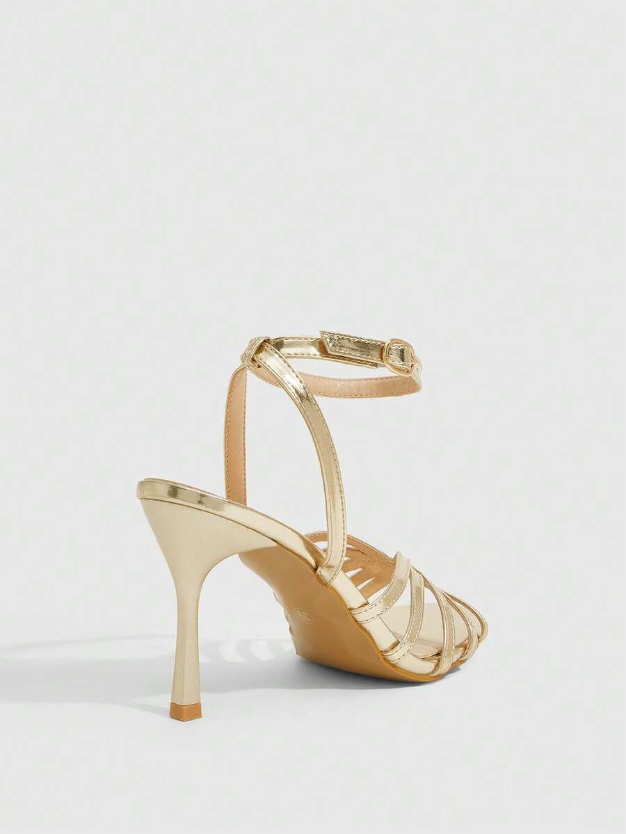 Women's champagne stiletto high heel sandals featuring knotted cross-over straps, open round toe, and adjustable ankle buckle strap.