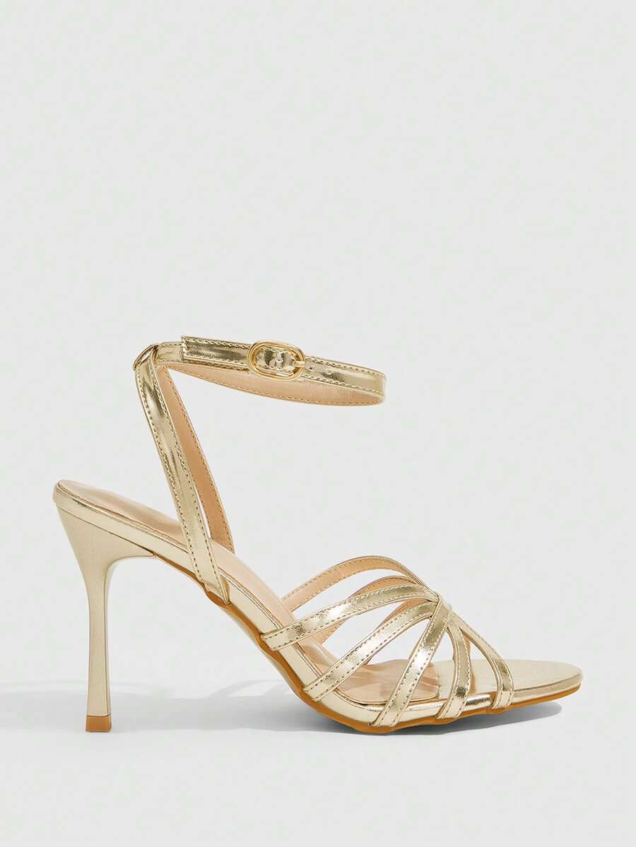 Women's champagne stiletto high heel sandals featuring knotted cross-over straps, open round toe, and adjustable ankle buckle strap.