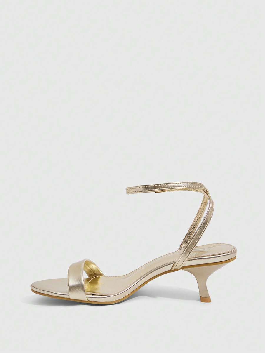 Women's open-toed high-heeled sandals featuring a 5.5cm kitten heel stiletto, sleek ankle strap with buckle closure, and smooth PU leather finish.
