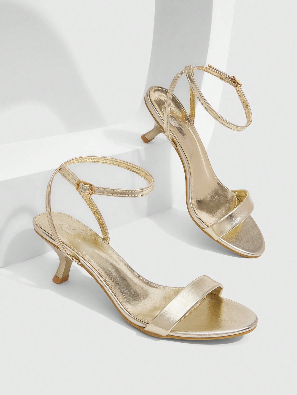 Women's open-toed high-heeled sandals featuring a 5.5cm kitten heel stiletto, sleek ankle strap with buckle closure, and smooth PU leather finish.