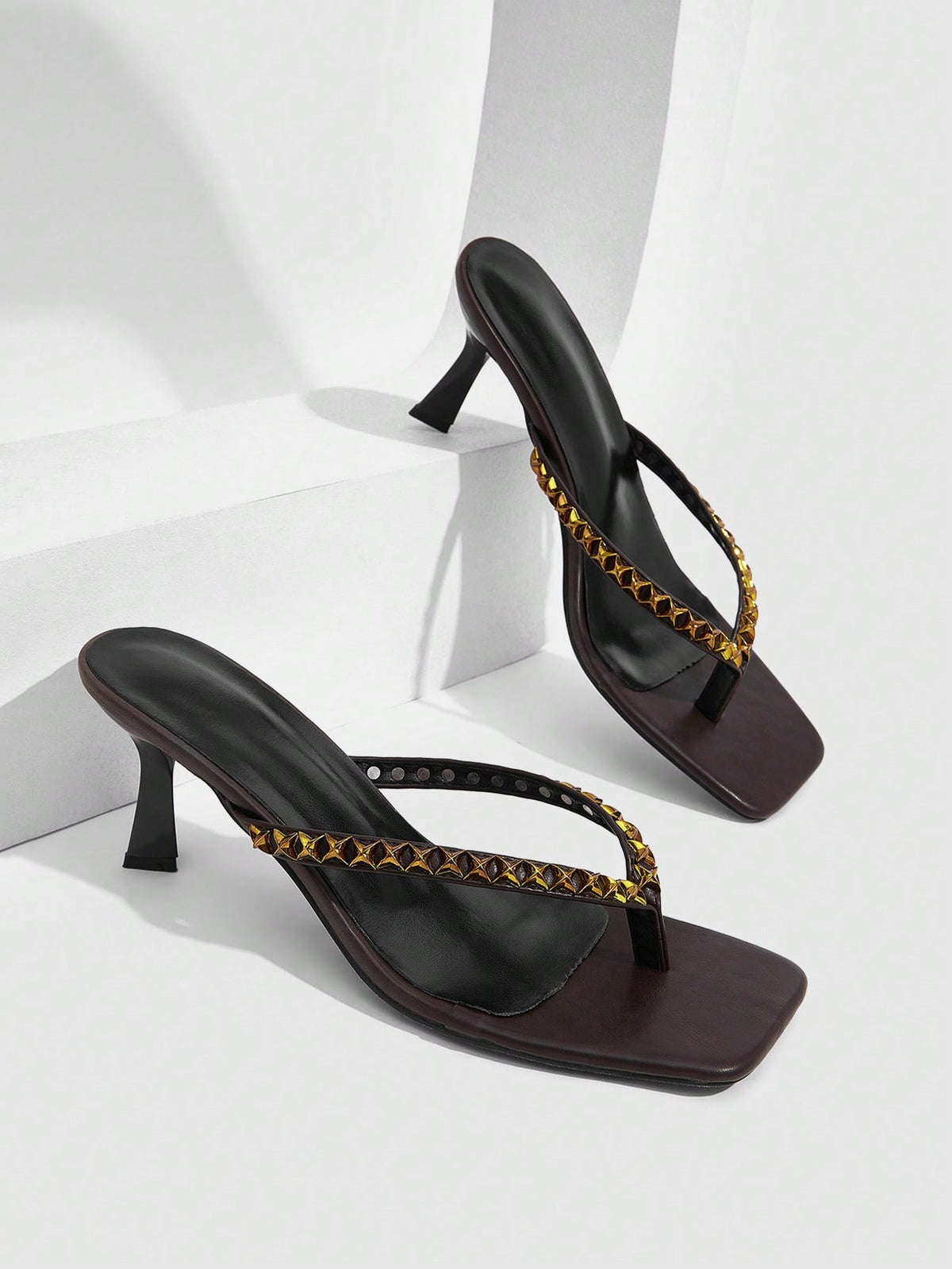 Elegant ladies strappy high-heeled slippers featuring a sleek toe post, buckle accent, and stiletto mid heel in smooth PU leather.