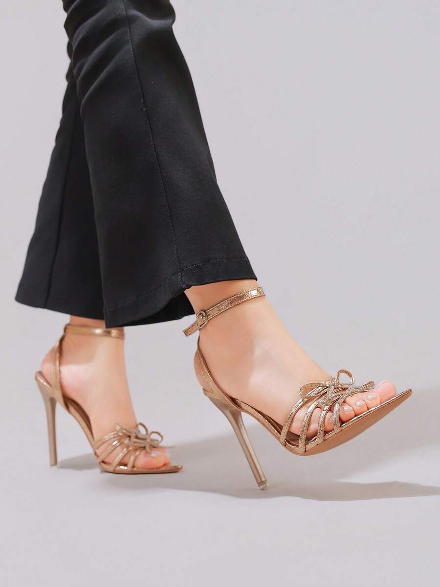 Lace stiletto high heel sandals with pointed open toe, ankle strap buckle, and bow detail