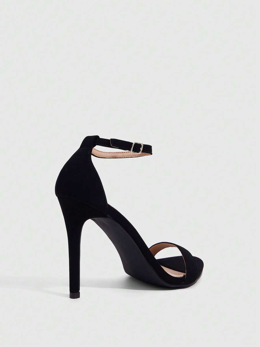 Women's stiletto sandals featuring an ankle strap buckle closure and classic round open toe design.