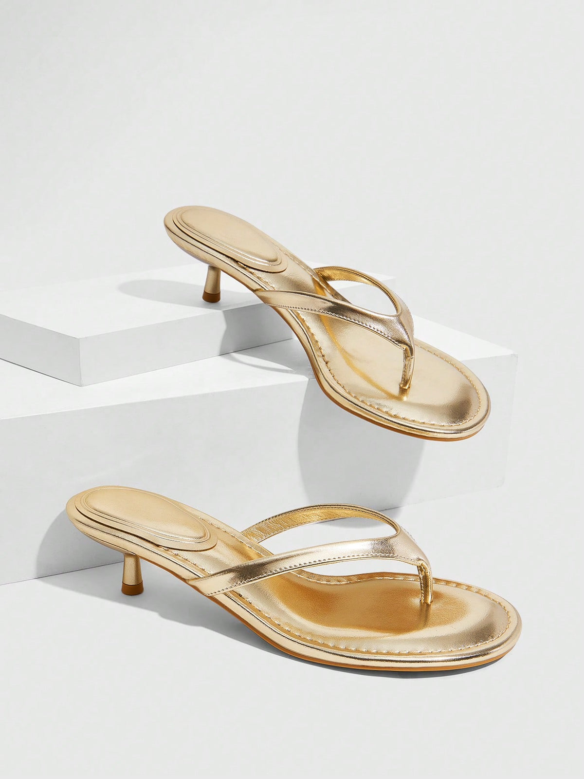Women's kitten heel flip flop sandals featuring sleek PU leather straps, open toe, and low kitten heel.