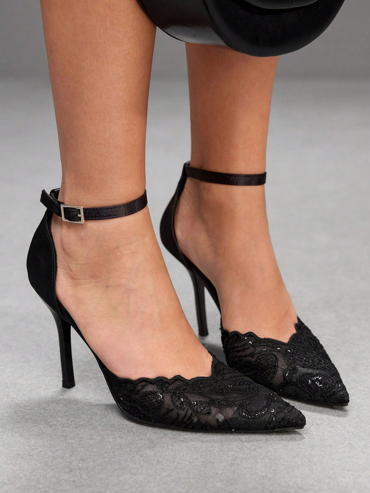 Women's stiletto high heel shoes featuring an elegant buckle detail and ankle strap slingback design.