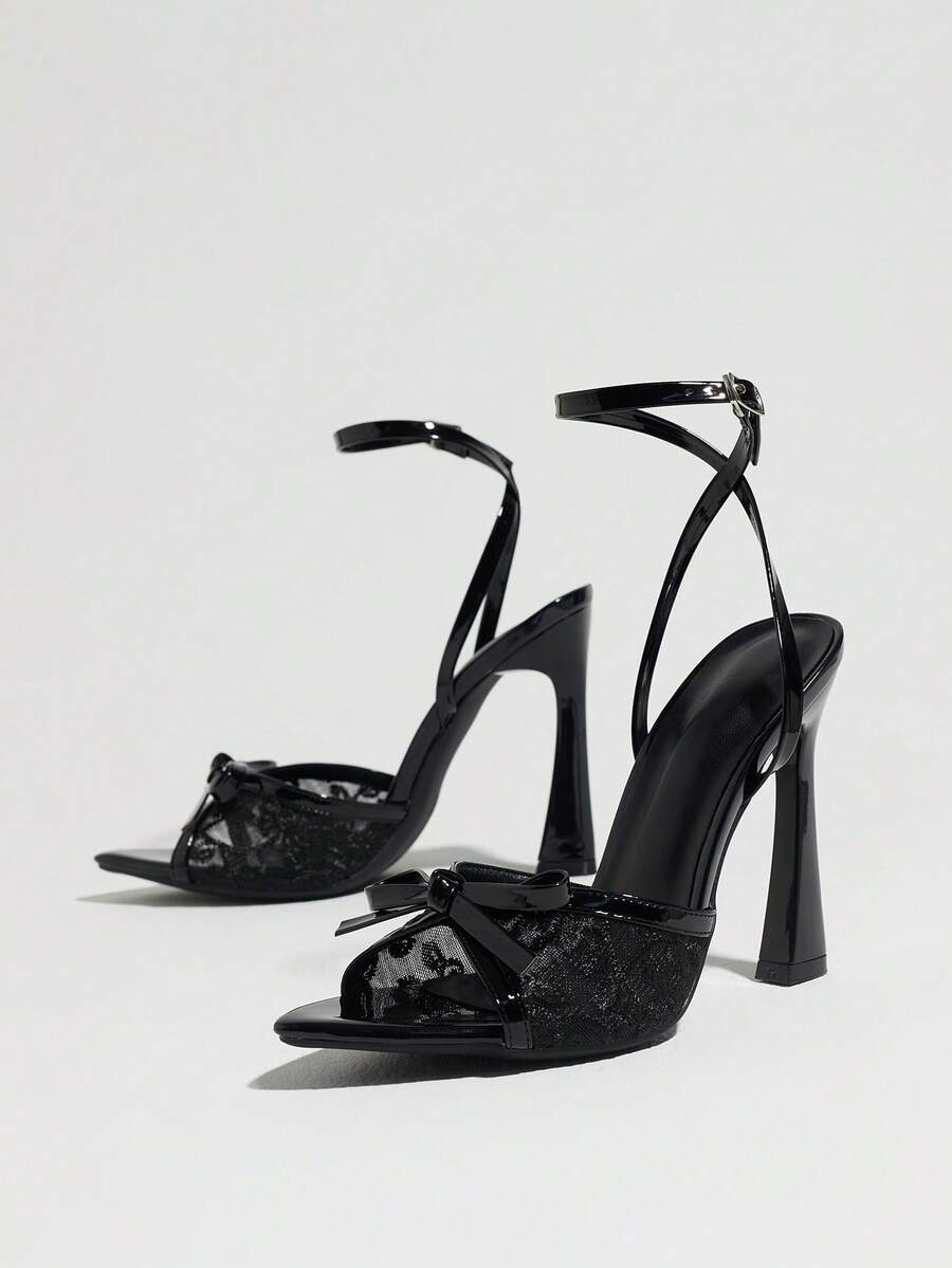 Burgundy open-toe high heels featuring an adjustable ankle strap with buckle closure and high stiletto heel.
