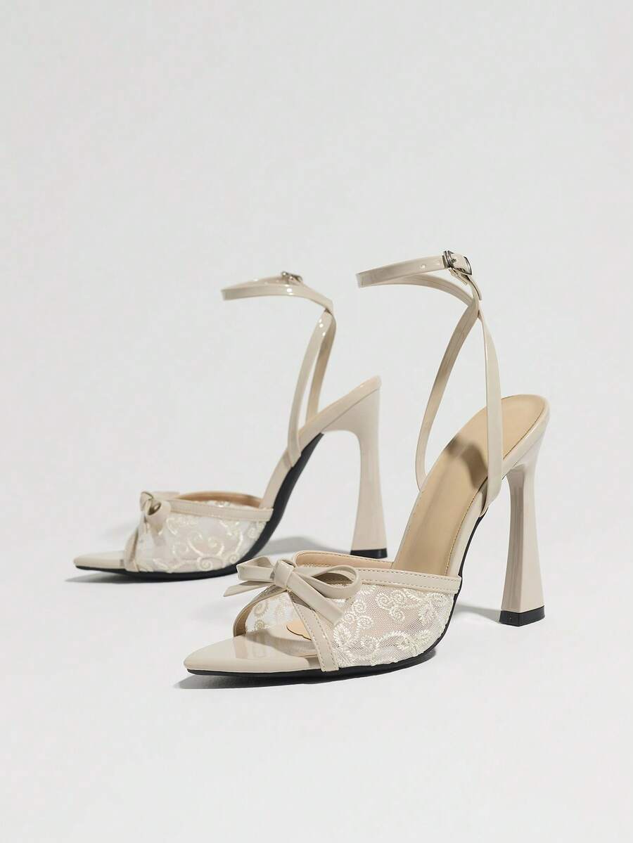 Burgundy open-toe high heels featuring an adjustable ankle strap with buckle closure and high stiletto heel.