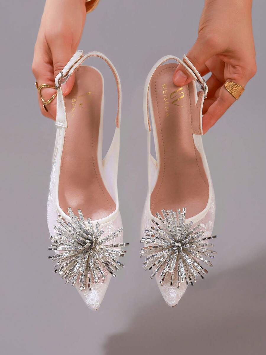 White pointed toe high heel stiletto sandals featuring lace patchwork, fringe trim, and an oversized bowknot accent.