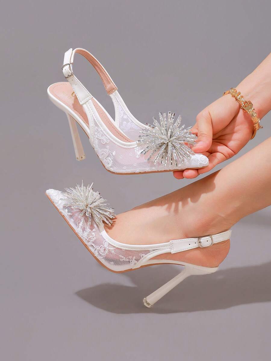 White pointed toe high heel stiletto sandals featuring lace patchwork, fringe trim, and an oversized bowknot accent.