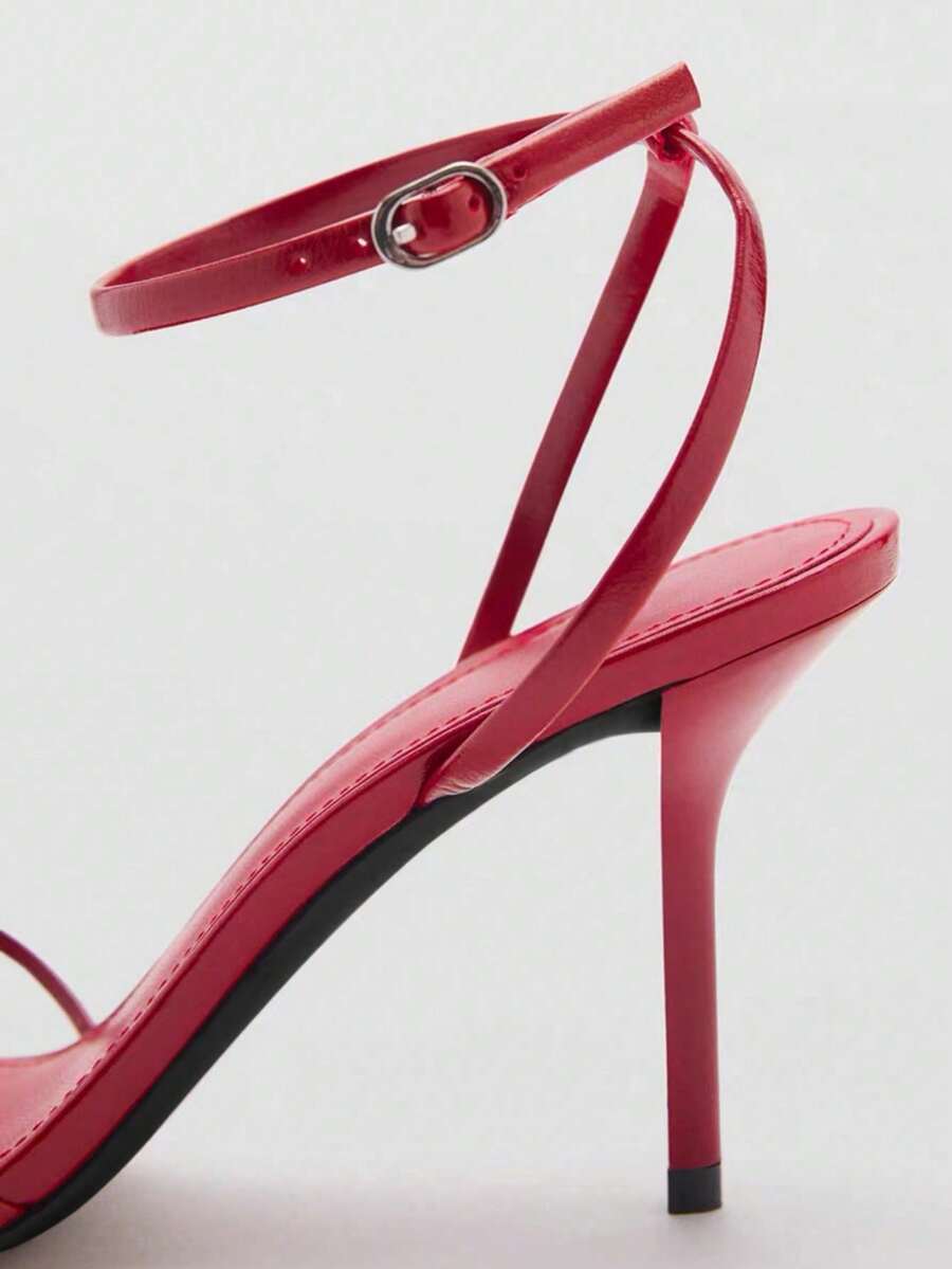Women's open toe stiletto high heel sandals featuring metallic knot decor and an adjustable ankle buckle strap.