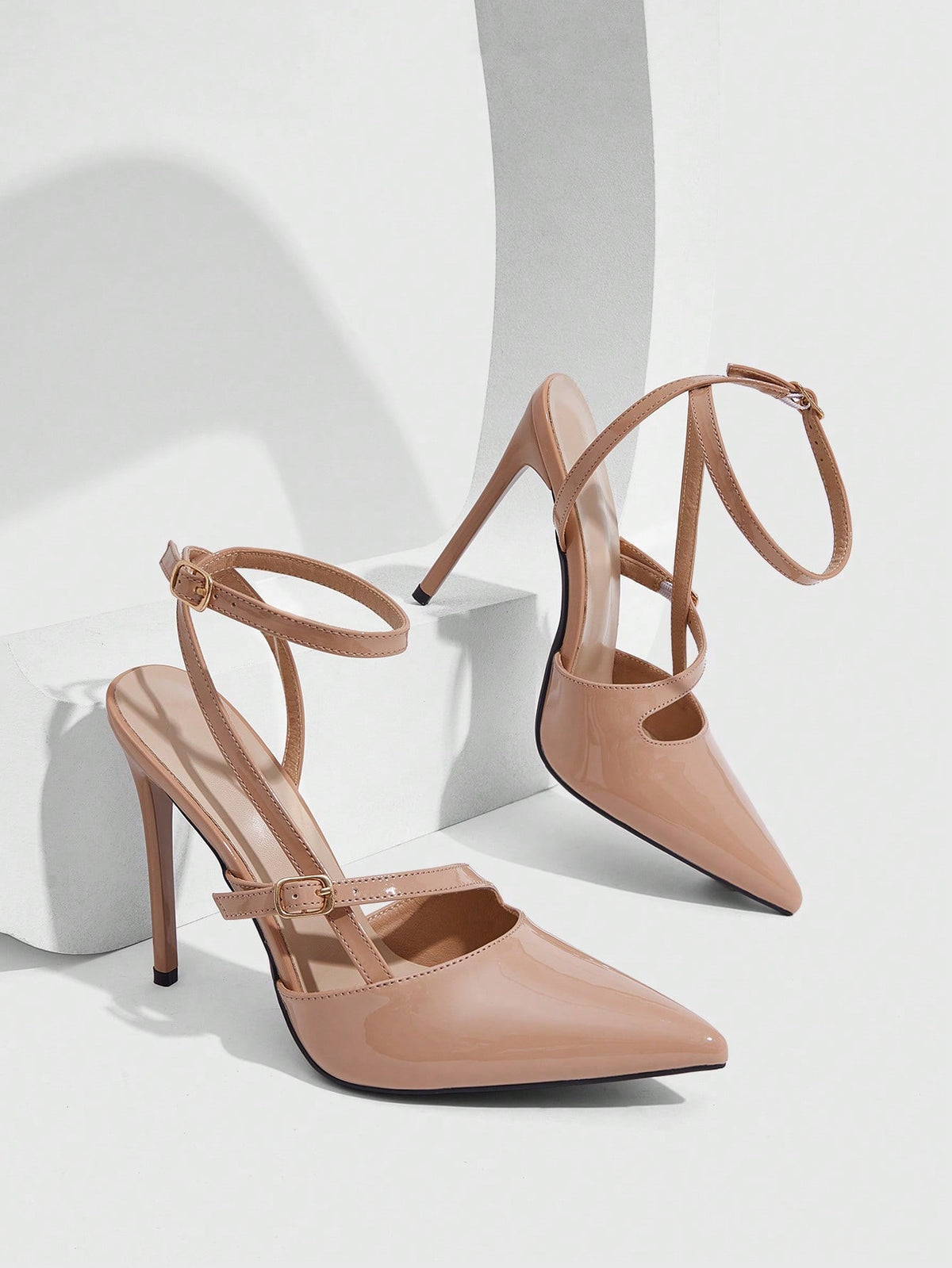 Pointed toe stiletto high heels with slingback silhouette and adjustable buckle ankle strap.