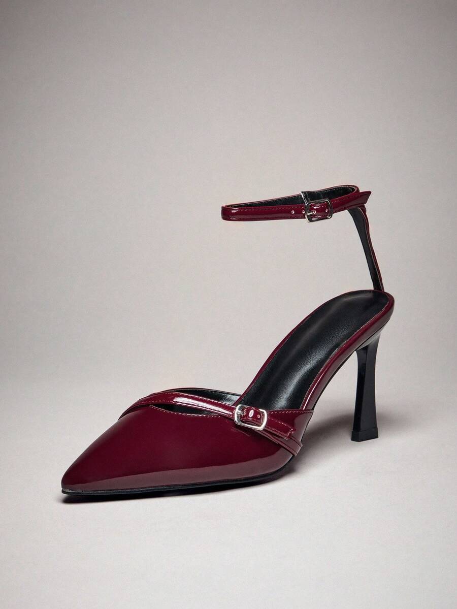 Women's pointed toe stiletto heel slingback pumps in chocolate brown with double metal buckle strap details.